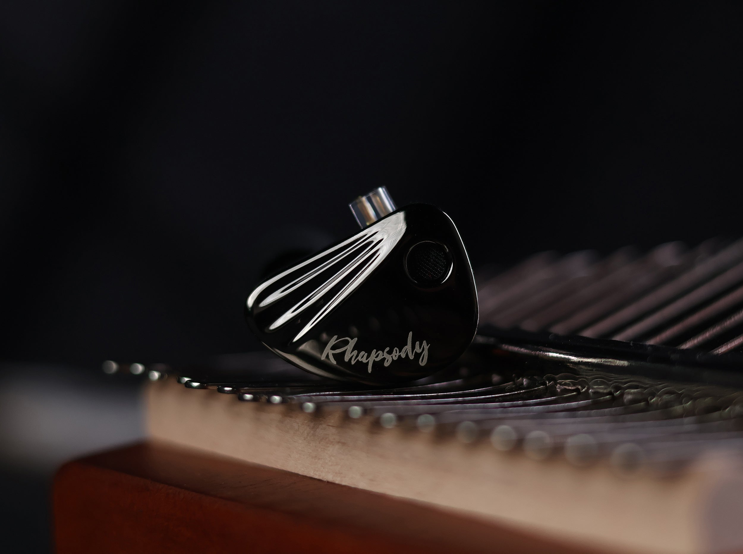 Side view of CCA Rhapsody IEM showing ergonomic shell and faceplate